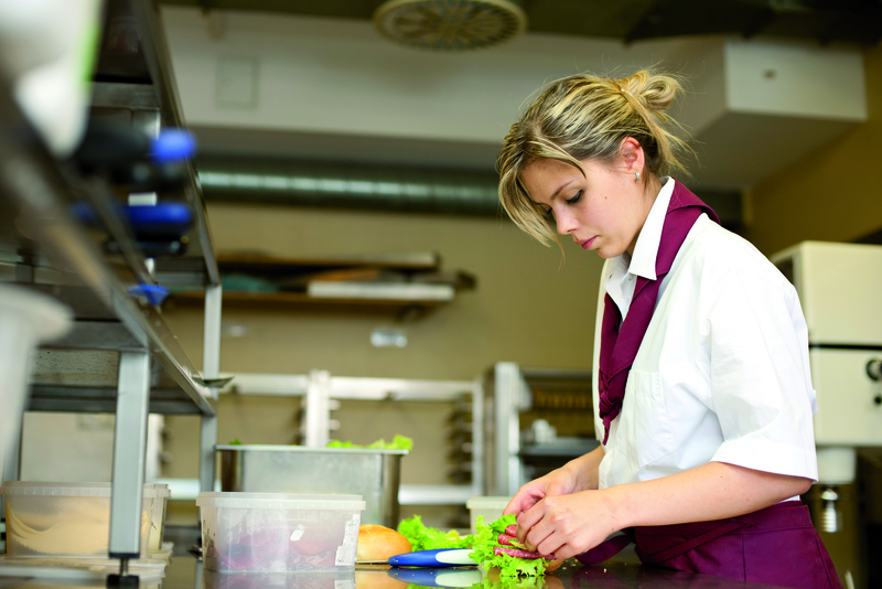 Verkäuferin belegt Brötchen
