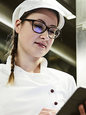 Bäckerin schreibt was auf ein Klemmbrett