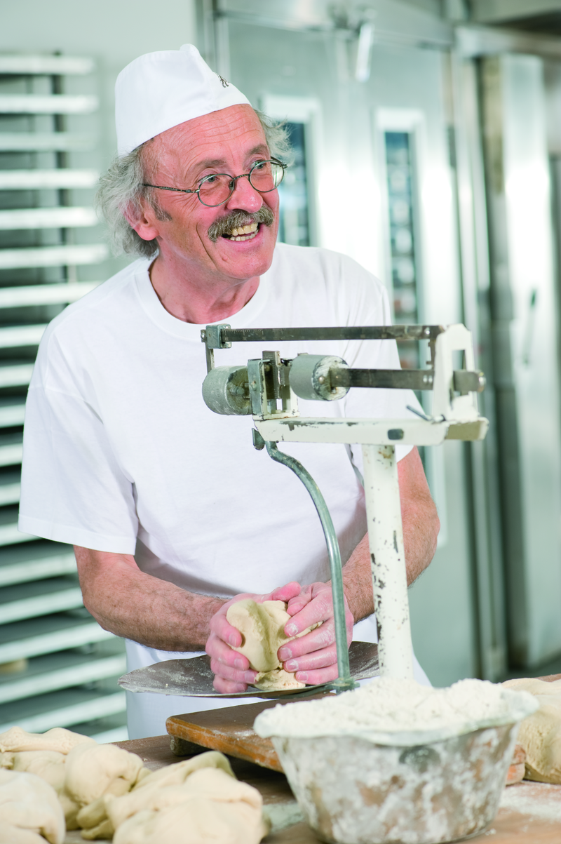 Bäckermeister wiegt Teigstücken