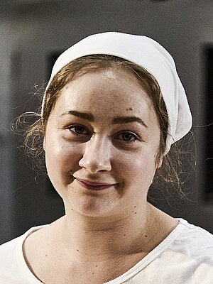 Bäckerin beim Teig kneten